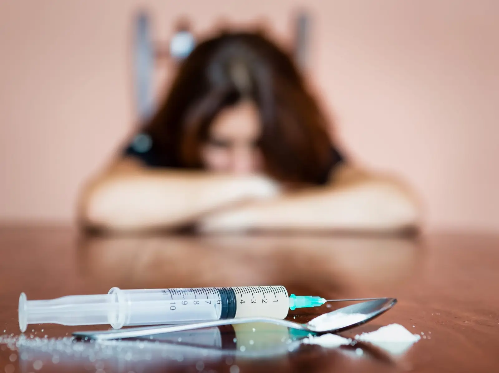 A woman near medication, representing the reality of opioid use disorder