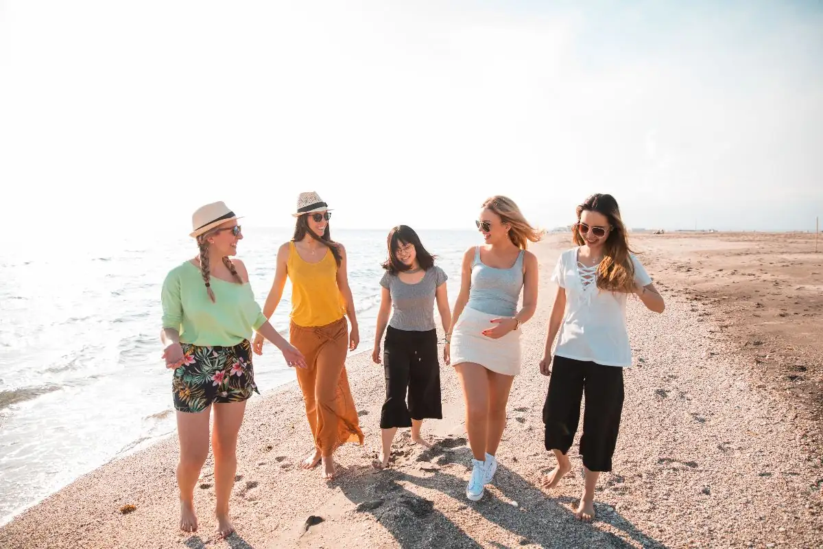 A group of women walking together along the beach