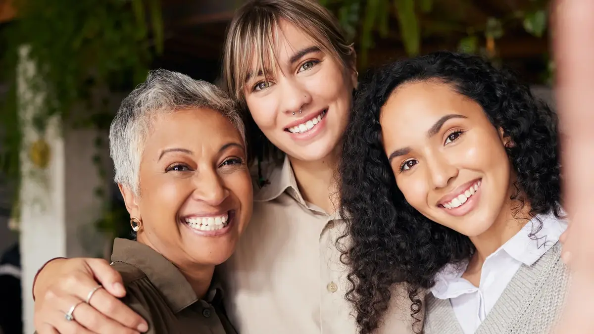 Three generations of women smiling together