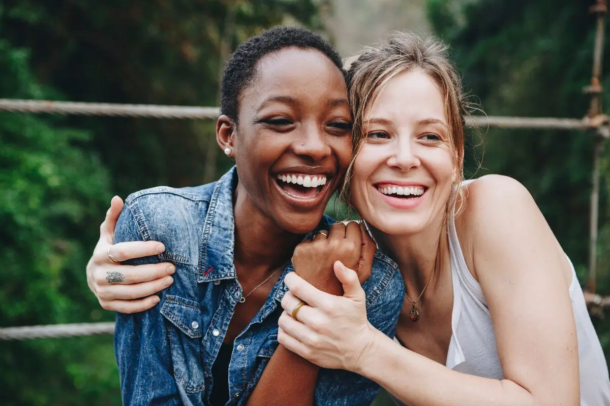 Two women laughing and embracing