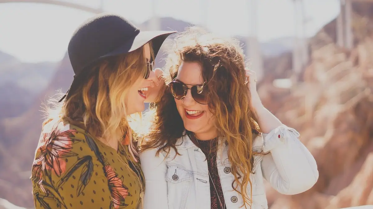 Two women laughing together outdoors