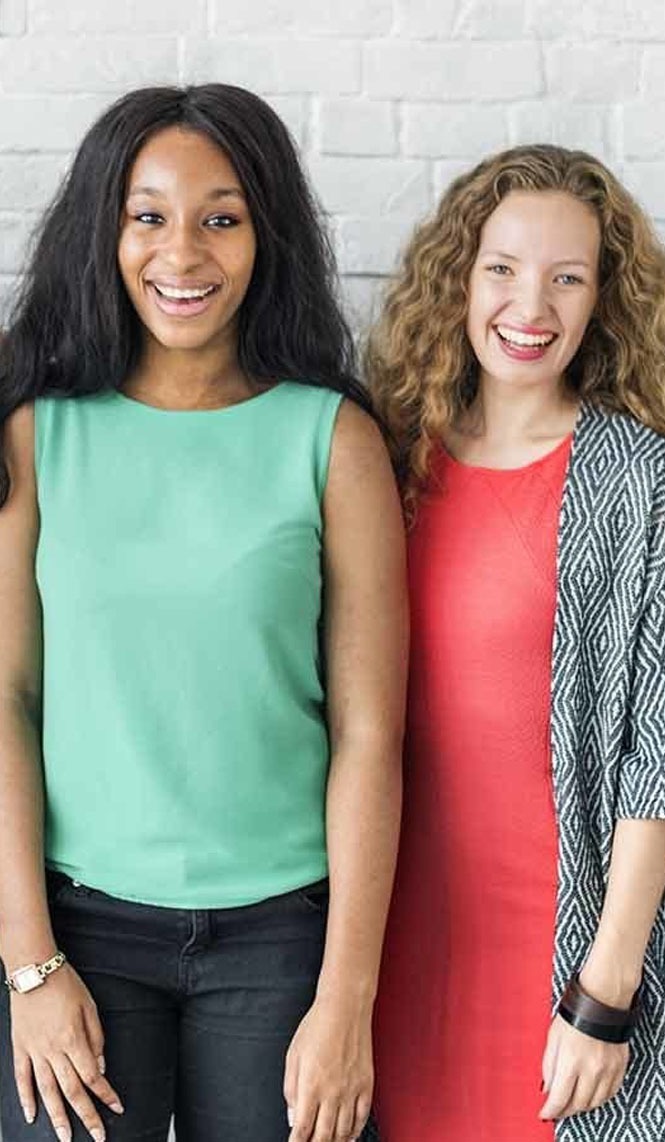 Two women standing together and smiling