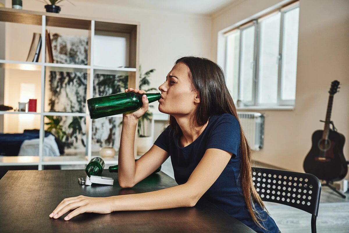 relapse from recovery - woman drinking unhappily