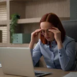 overcoming shame and guilt - female working professional ashamed at her desk