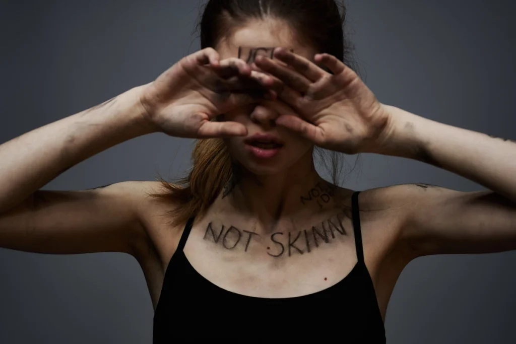 girl has not skinny written across body - body dysmorphia - anorexia