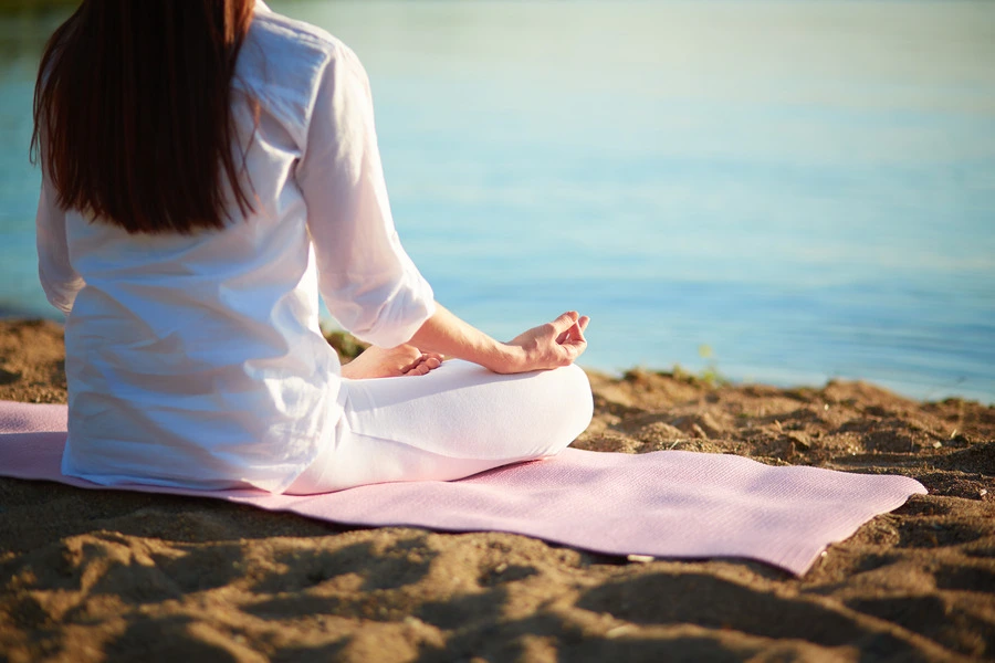 female sitting in serenity on the beach
